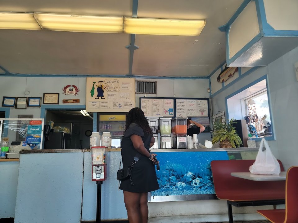 Seafood restaurant interior with simple tables and chairs.