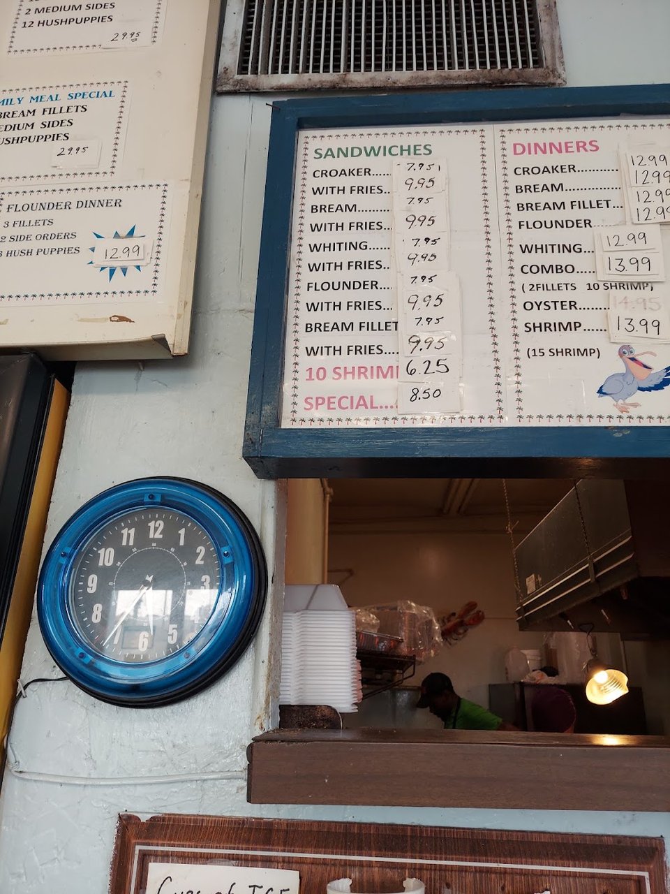 Seafood menu with sides like fries and slaw.